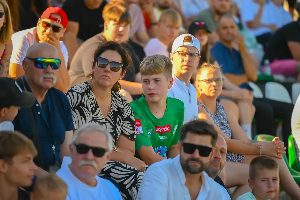 Publiczność na stadionie Dorośli i dzieci oglądają mecz z trybuny stadionu Pelikana Łowicz.